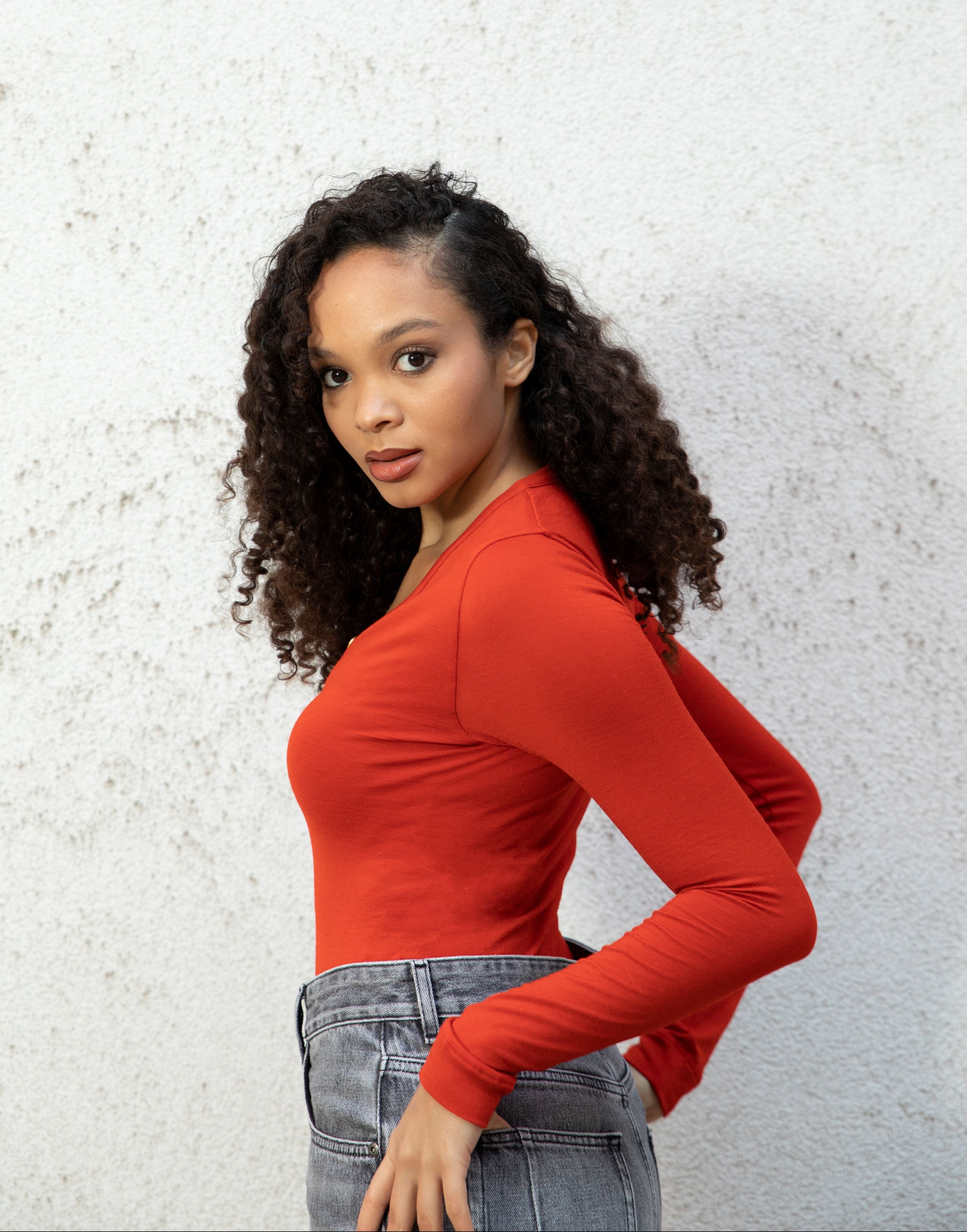 MARA bodysuit — long-sleeve button V-neck bodysuit with jeans seamless bodice side-view, burnt red
