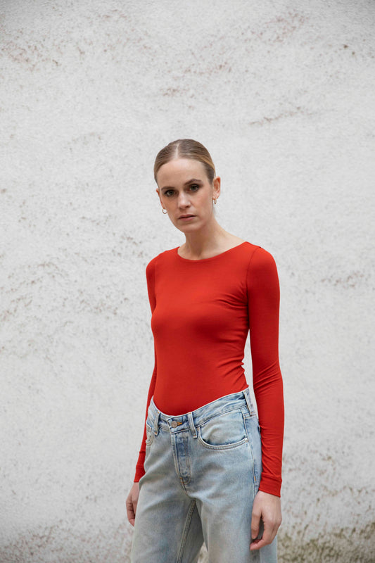 VALENTINA boatneck top styled with jeans, three-quarter view, burnt red