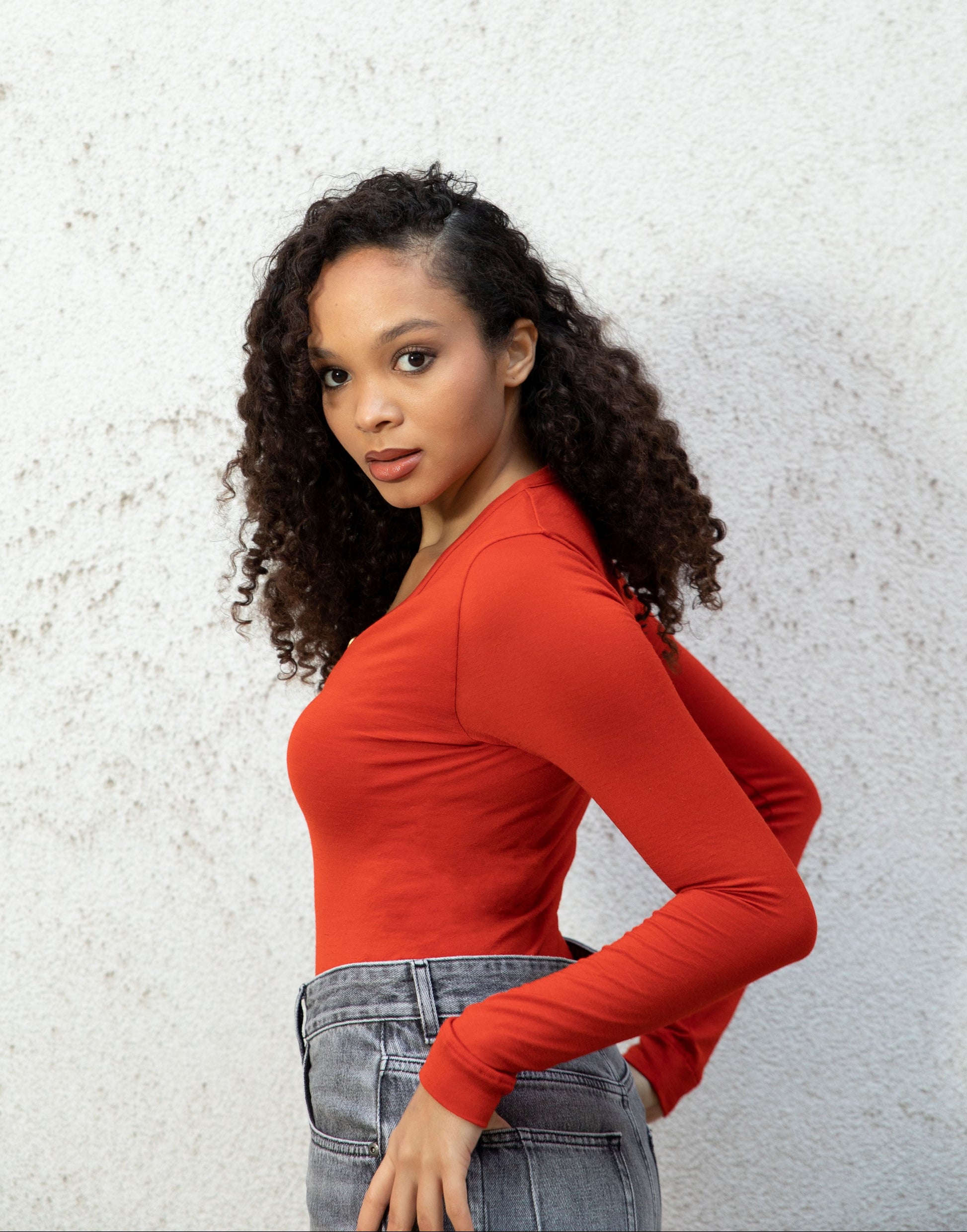 MARA bodysuit — long-sleeve button V-neck bodysuit with jeans seamless bodice side-view, burnt red