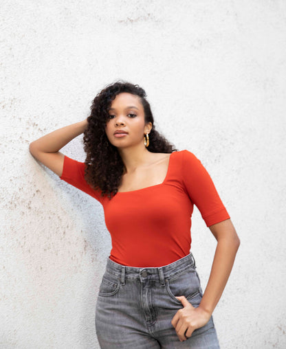 MIA square-neck top styled with jeans, tucked in, front view, burnt red