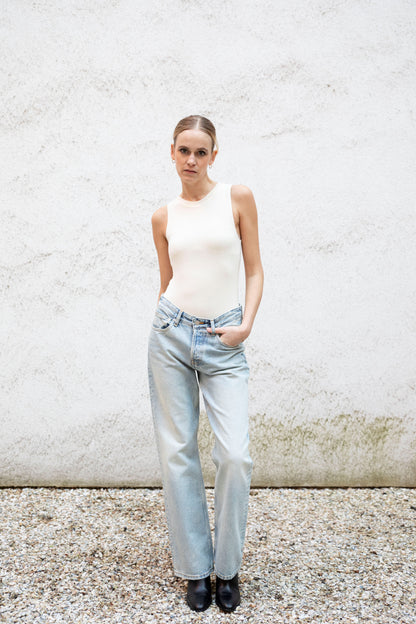 CLEO superfine merino seamless bodice tank bodysuit styled with jeans, front view, bright cream