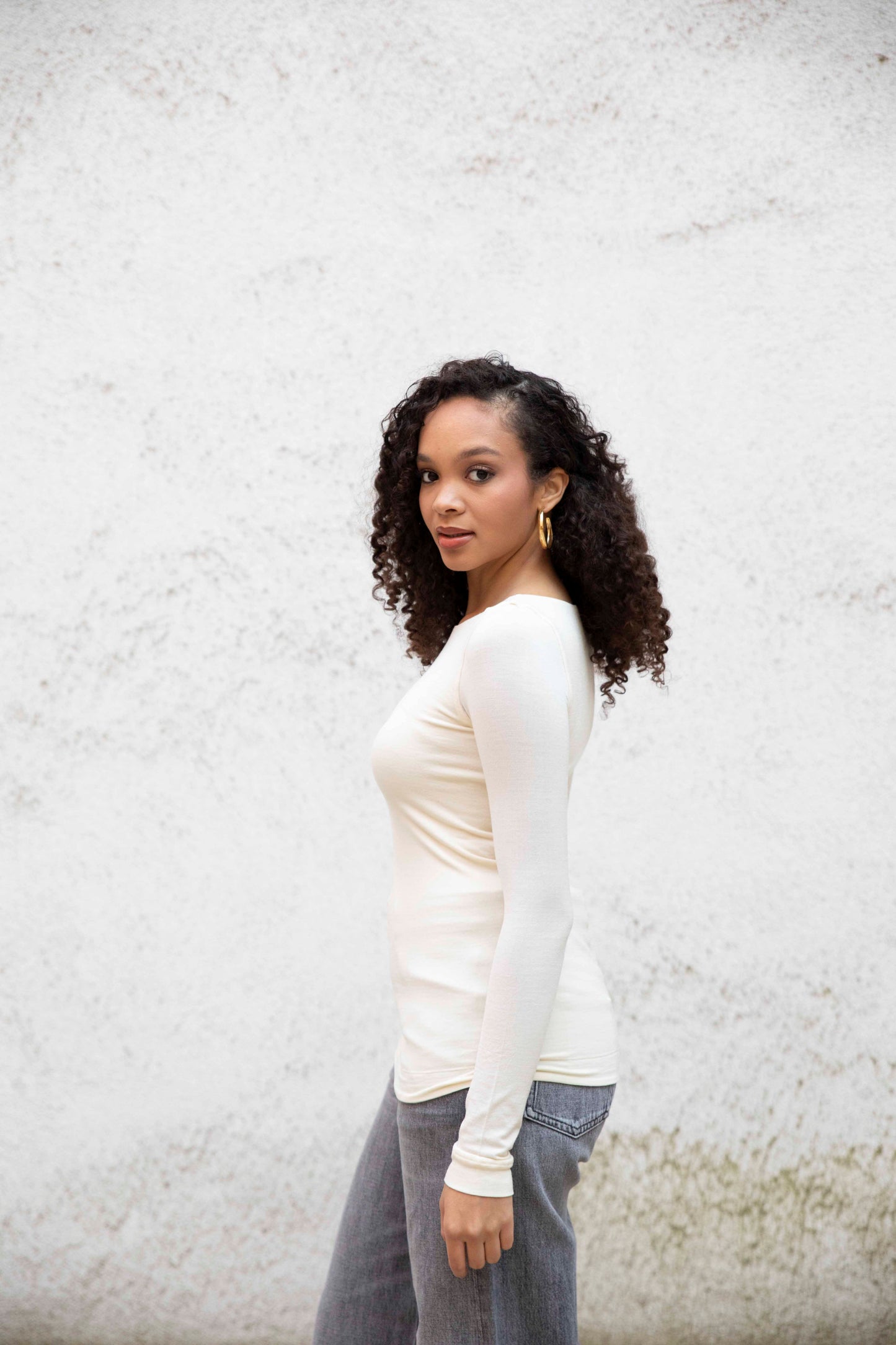 VALENTINA boatneck top with seamless bodice, styled with jeans, three-quarter side view