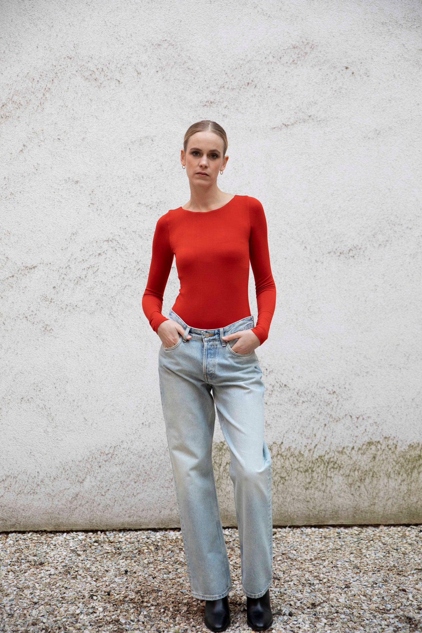 VALENTINA boatneck top styled with jeans and boots, front view, burnt red