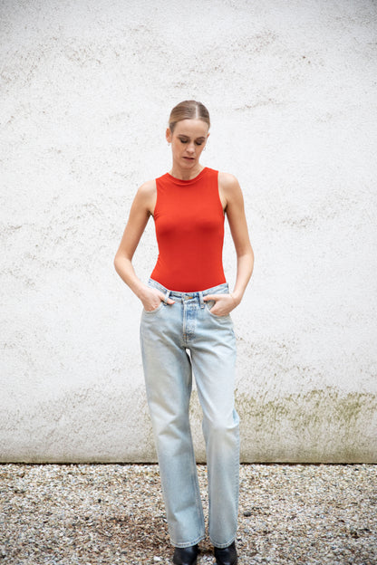 CLEO superfine merino seamless tank bodysuit styled with jeans and boots, A-frame, front view, burnt red