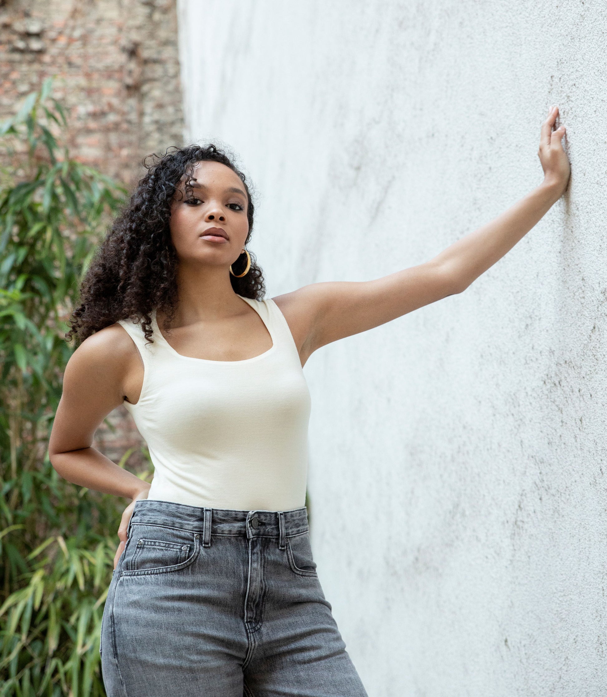 EMMI sweetheart-neck bodysuit styled with jeans, front view, bright cream