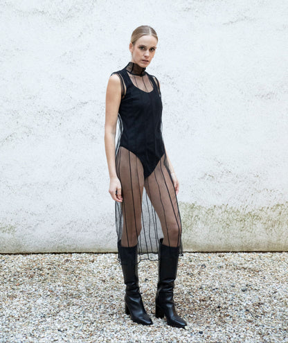 EMMI sweetheart-neck bodysuit styled with transparent dress and boots, side view, black